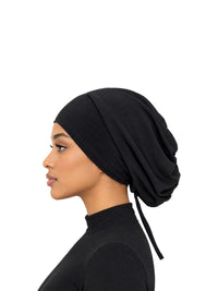 Imaarah Luxe Ruched Mod Cap in black, side view on model