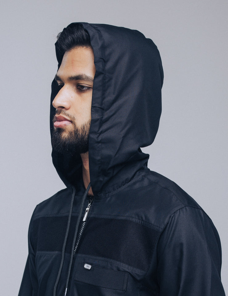 Amaani Drift Hooded Thobe, Black, model wearing hood up, side