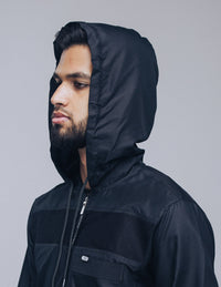 Amaani Drift Hooded Thobe, Black, model wearing hood up, side