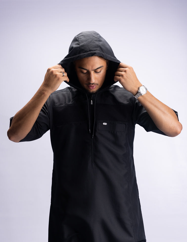 Amaani Drift Short Sleeve Thobe, Black, model pulling hood up