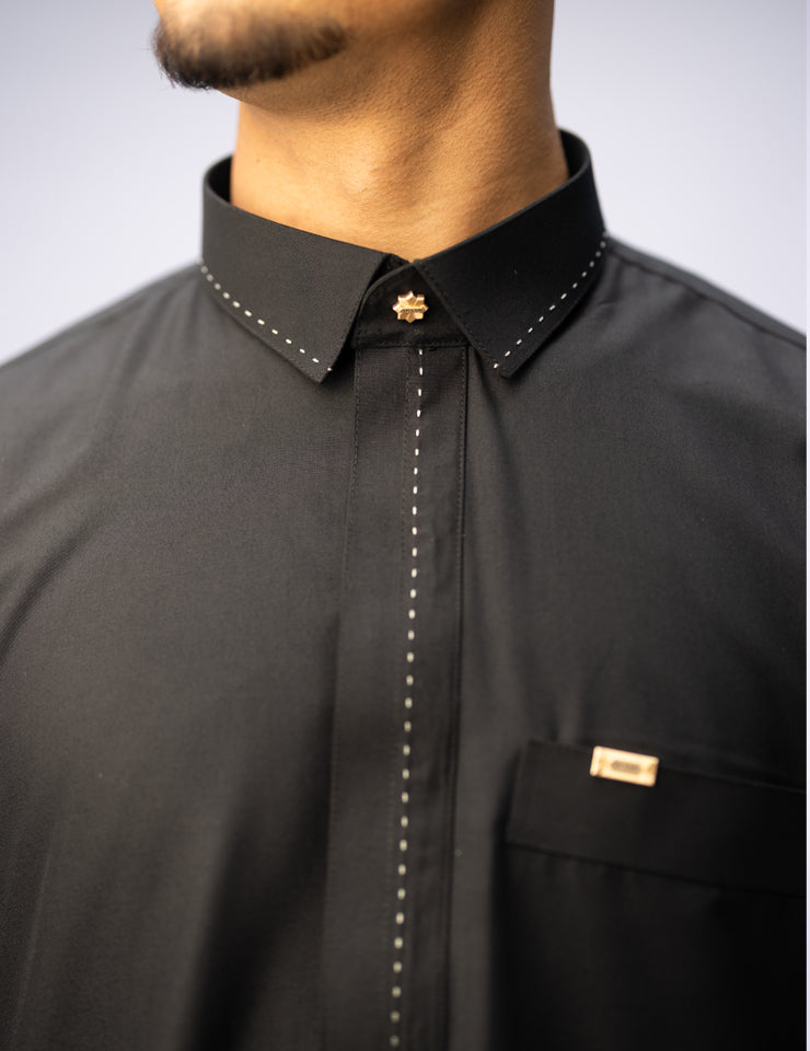 Amaani Iconic Black Thobe, Onyx Black, shirt collar and embroidered placket on model