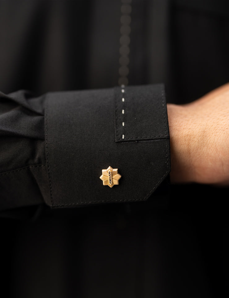 Amaani Iconic Black Thobe, Onyx Black, cuff stitching and signature button close up