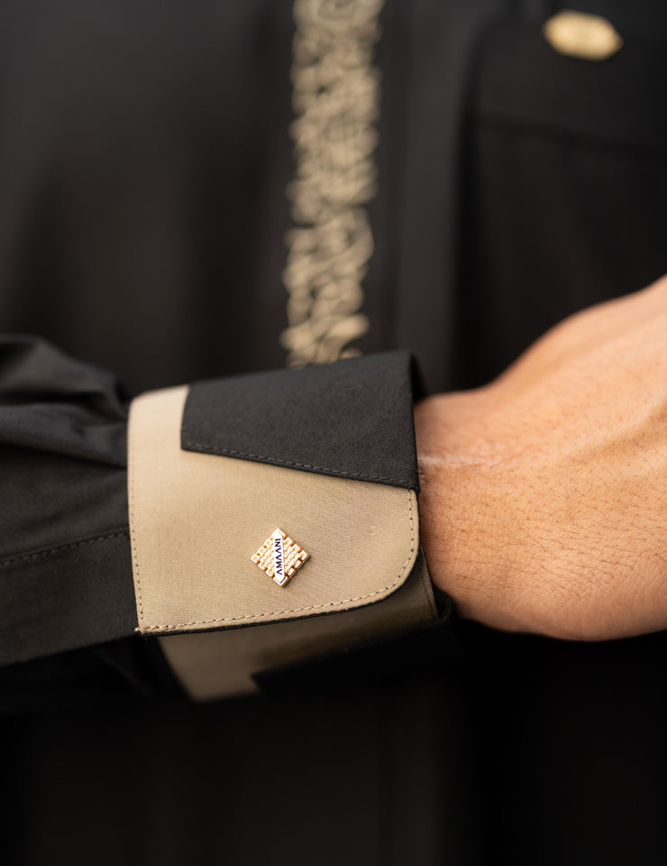 Amaani Noir Calligraphy Thobe, Black, architectural cuff and beige contrast close up