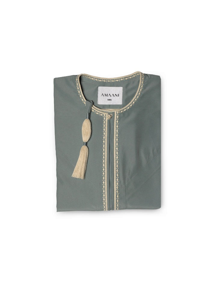 Amaani Omani Thobe, Aura (Stone Blue), folded flat lay showing cream placket embroidery and collar tassel