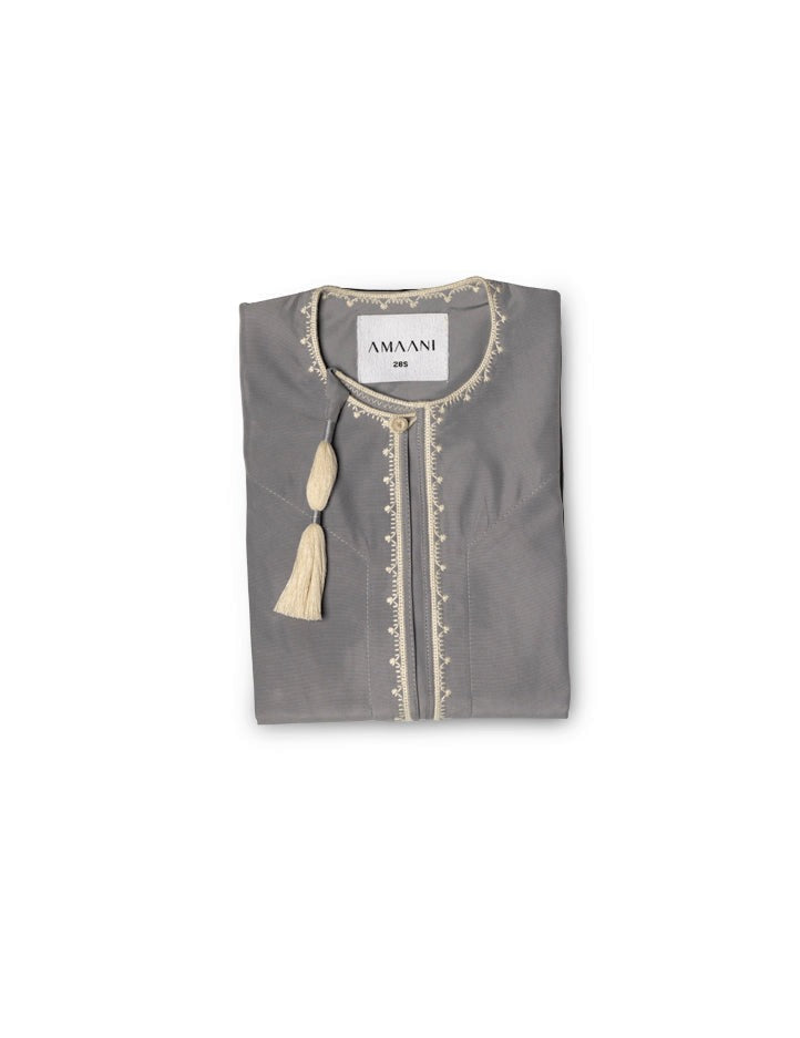 Amaani Omani Thobe Kids, Fossil (Grey), folded flat lay showing cream placket embroidery and collar tassel