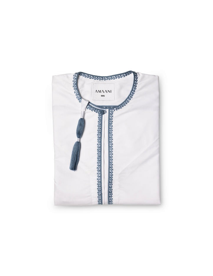 Amaani Omani Thobe, Topaz (White & Blue), folded flat lay showing cerulean placket embroidery and collar tassel