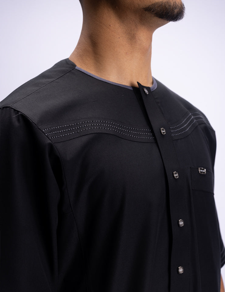 Amaani Silhouette Short Sleeve Thobe, Black, sleeve embellishment and collarless neckline on model